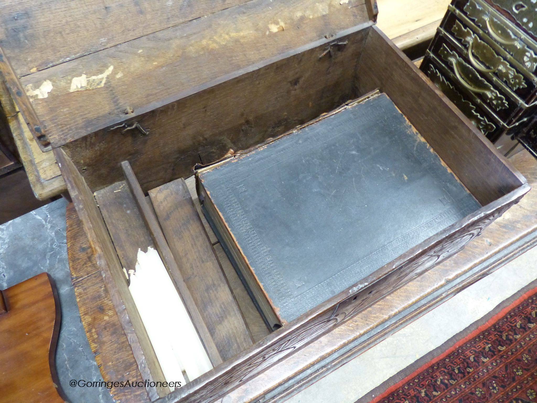 A 17th century carved oak bible box with bible, width 56cm, depth 36cm, height 22cm